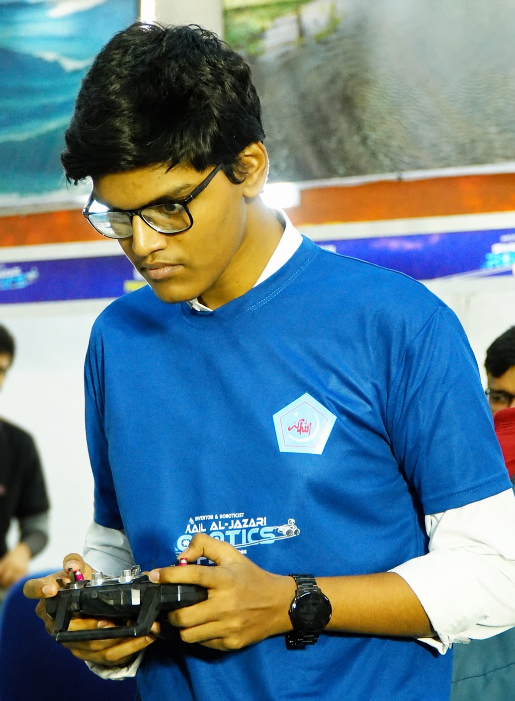 Al Amin Sani focused while controlling a robot