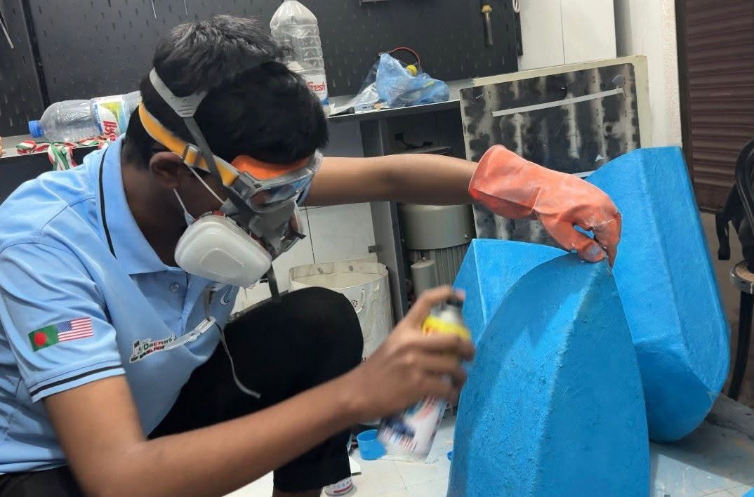 Al Amin Sani coating the hull during construction of DoB Joljan